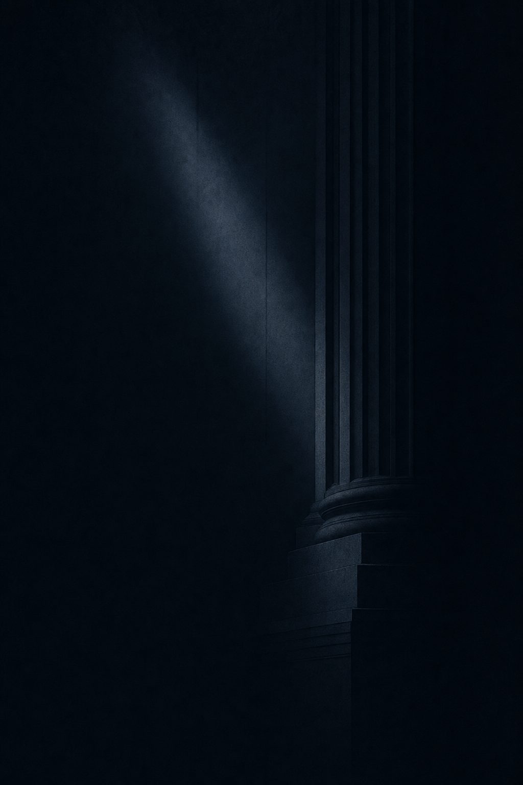 A single monumental column emerging from deep shadow, touched by a shaft of light
